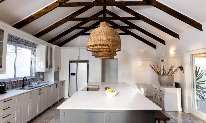A large modern kitchen with visible ceiling strats.