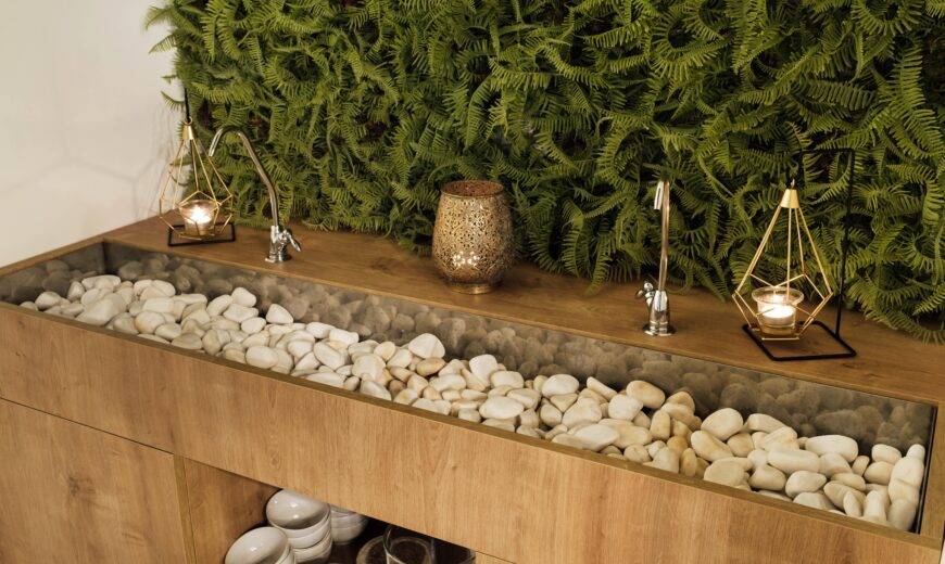 A two person bathroom sink full of stones.