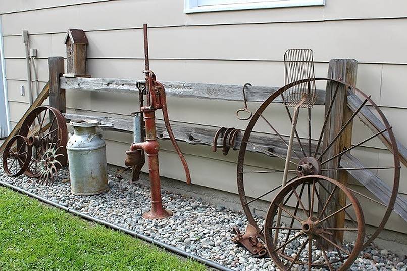 Vintage wheels, pump and jar on gravel