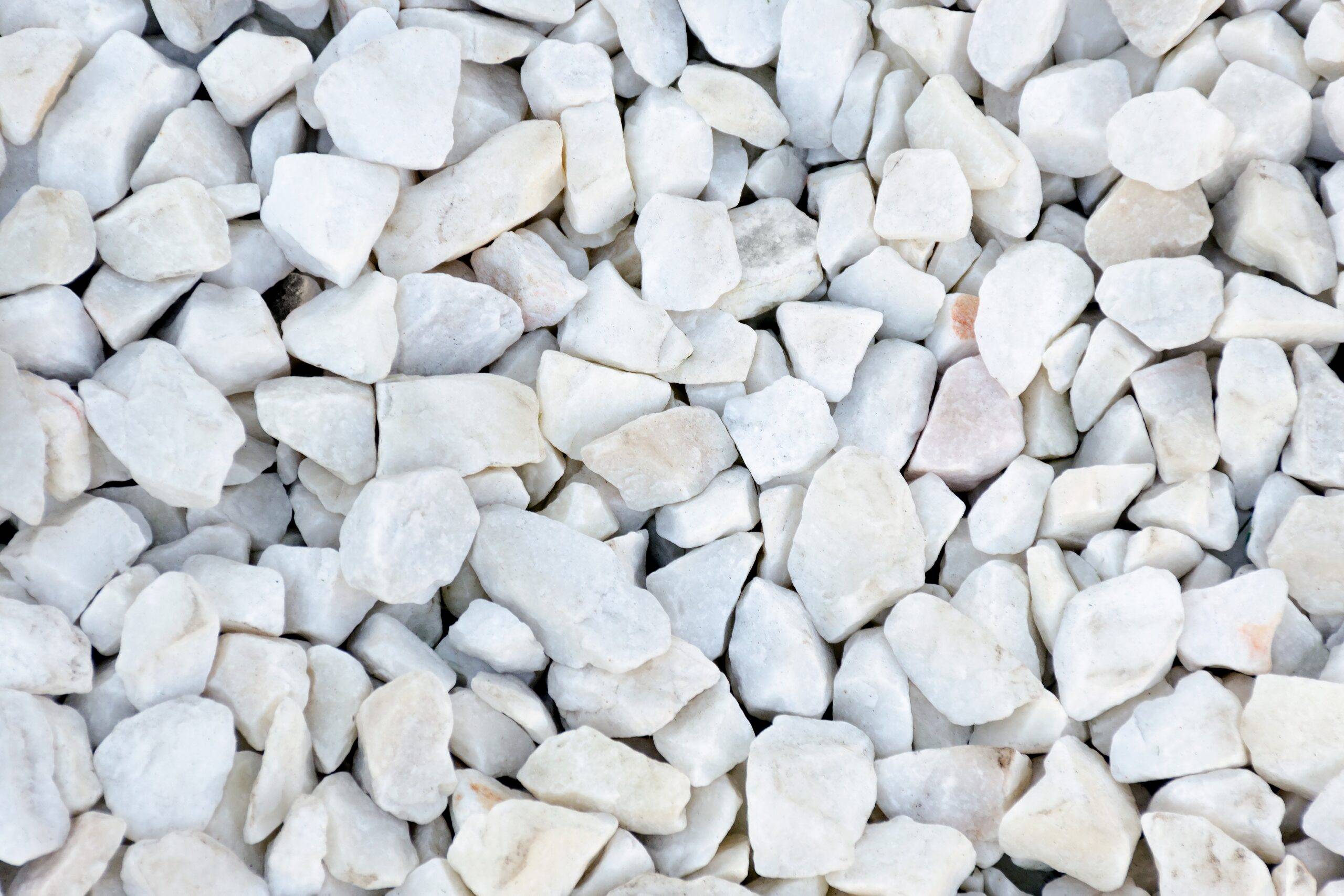 Small stones of white color with gray-blue tint. Close up texture.