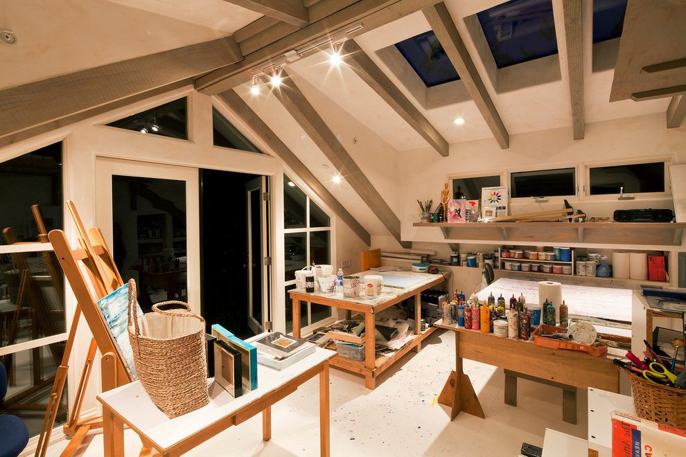 A modern art studio with wooden ceiling beams.