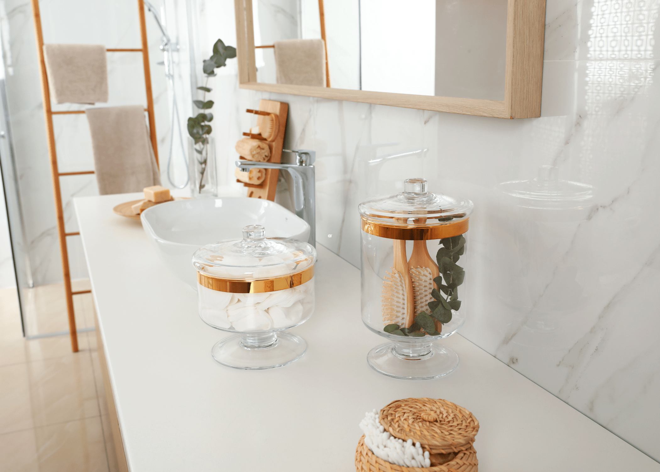 white bathroom countertop with spa apothecary jars and white bowl sink