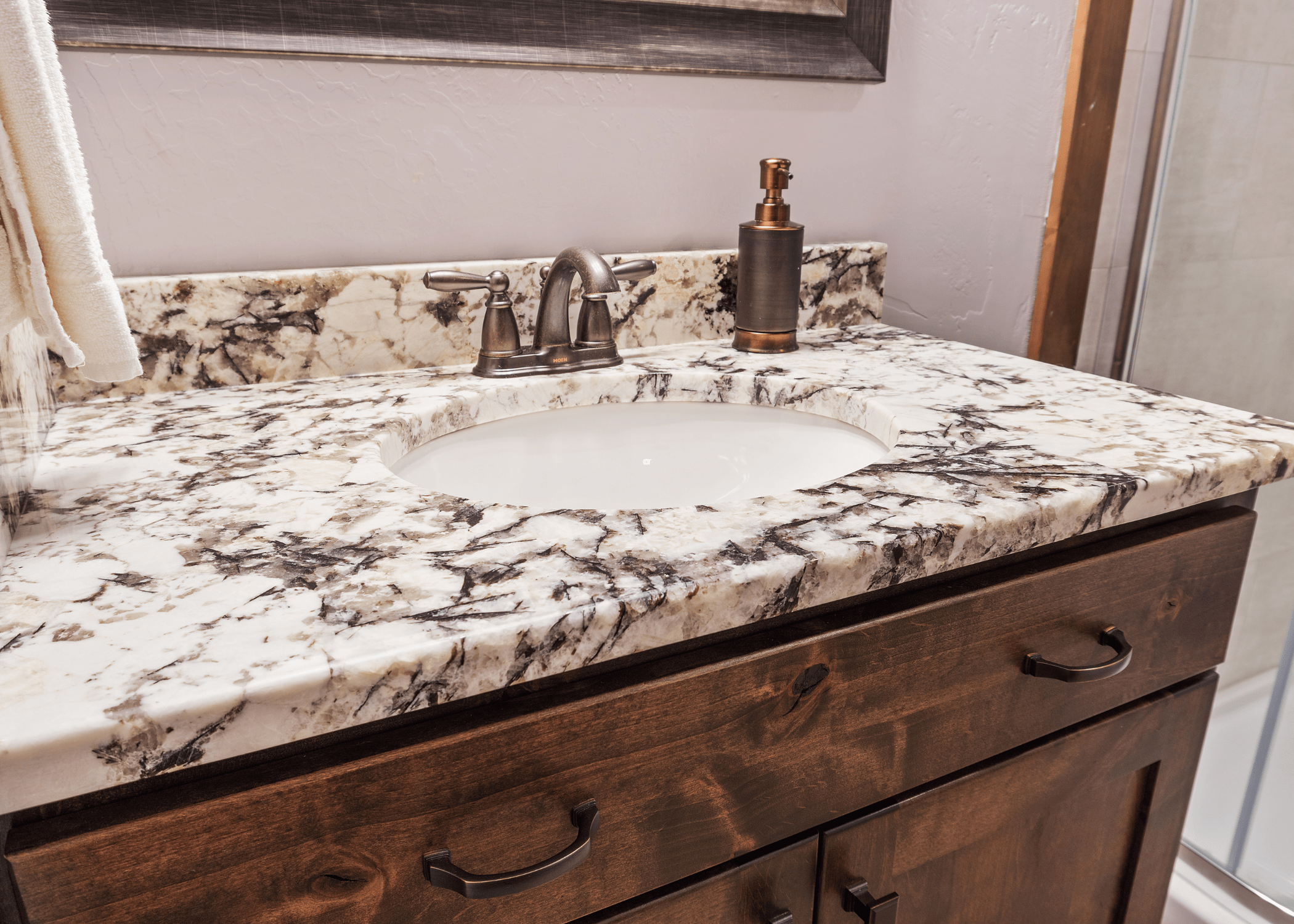 marble bathroom countertop with bronze faucet